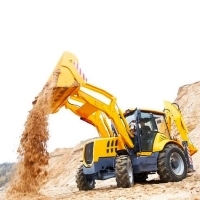 a yellow excavator is dumping dirt on a hill