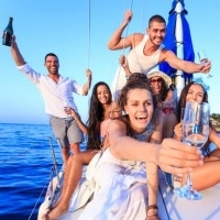a group of people on a boat with wine glasses