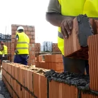 a man in a yellow vest and a white helmet