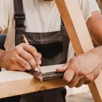 a man in a woodworking shop working on a piece of wood