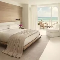 a bedroom with a large bed and a chair