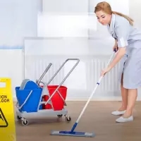 a woman cleaning a floor with a mop
