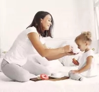 a picture of a child sitting on the floor with a toothbrush