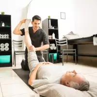 a man doing a yoga exercise with a woman