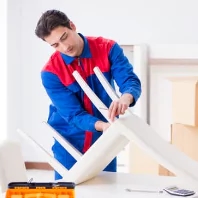 a man in a red and blue suit is working on a computer