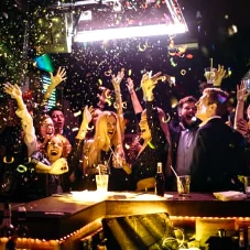 a party scene with confetti falling from the sky
