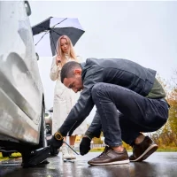 a man bending over to pick up a shoe