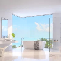 a bathroom with a large window and a view of the ocean