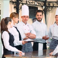 a group of chefs standing around a table