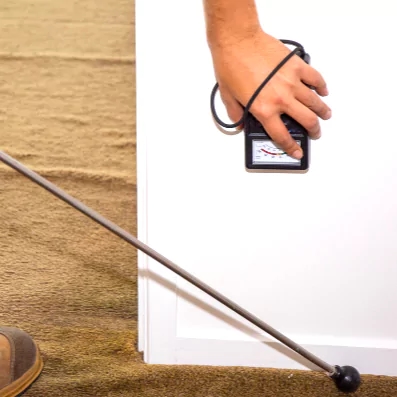 a golf ball and a person's hand with a golf club