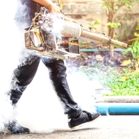 a man with a gun and a bag of smoke
