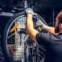 a man working on a motorcycle with a helmet on