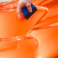 a person cleaning a car with a sponge