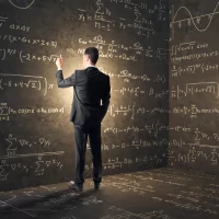 a man in a suit standing in front of a chalkboard