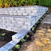a retaining wall in a garden with a concrete block
