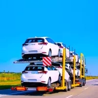 a truck carrying a car on a flatbed
