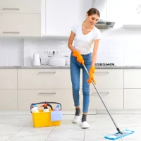 a woman mopping the floor with a mop