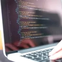 a person typing on a laptop computer
